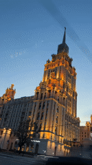 Moscow Stalinist skyscraper glowing under twilight sky