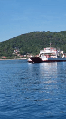 Ferry crossing documented in calm waters near Lepetane, Montenegro