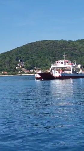 Ferry crossing documented in calm waters near Lepetane, Montenegro