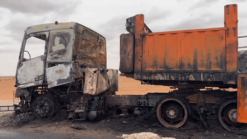 Gutted truck on a dirt road in Um Laba, Sudan