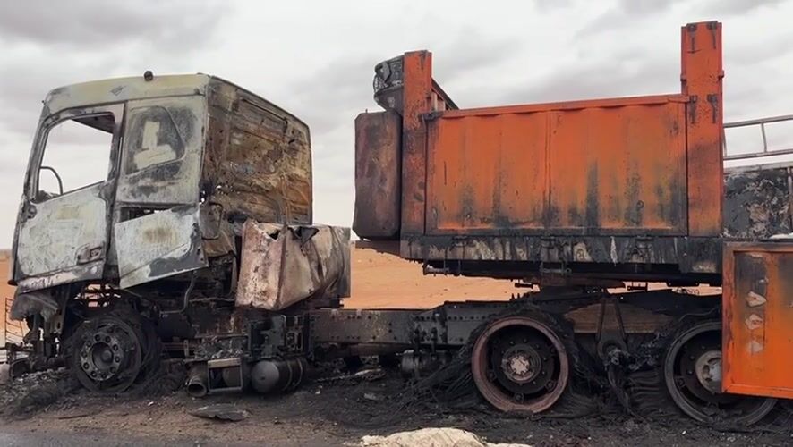 Gutted truck on a dirt road in Um Laba, Sudan