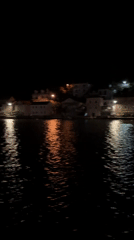 Night ferry crossing captured in Bay of Kotor, Montenegro