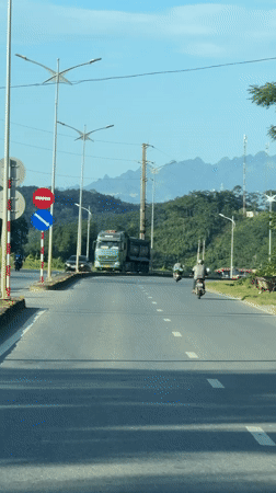 Vehicle records road scene with dump truck in Vietnam