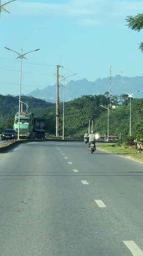 Vehicle records road scene with dump truck in Vietnam