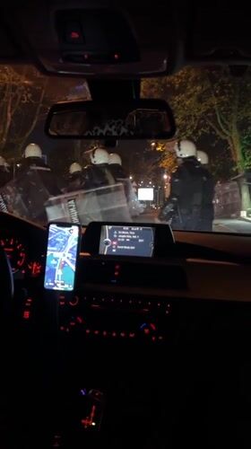 Driver navigates through riot police presence in Belgrade suburb