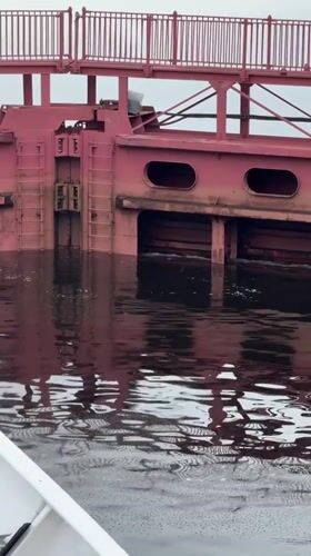 Ship navigates the Svir River lock system at Svirstroy