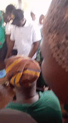 People queue under covered area in Tamale, Ghana