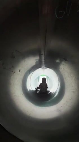 Inside a metal tube slide at a Khimki playground