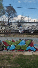 Train passenger documents 27-minute urban journey past landmarks, graffiti