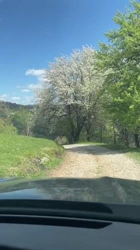 Vehicle travels rural gravel road in Montenegro countryside