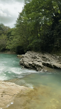 Turquoise river flowing through a lush canyon in Lebache, Georgia