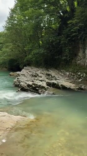 Turquoise river flowing through a lush canyon in Lebache, Georgia