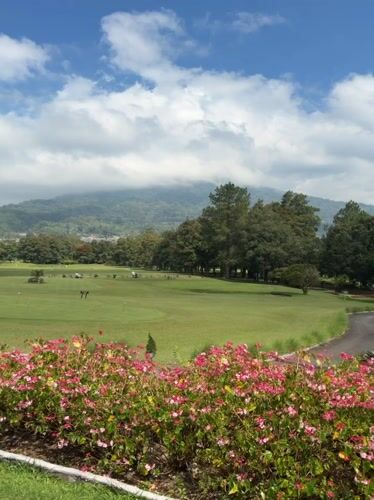 Morning at a mountain-backdrop golf club in Sukasada, Bali