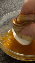 Cream-filled crepe dipped in orange jam in Gelendzhik