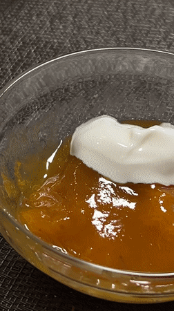 Cream-filled crepe dipped in orange jam in Gelendzhik
