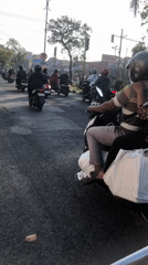 Morning motorcycle traffic flows through Candi and Larangan, Indonesia