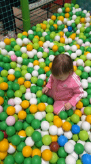 Toddler plays at Moscow entertainment center with ball pit