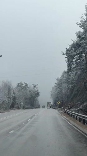 Vehicle travels snowy road in Lagerite, Bulgaria