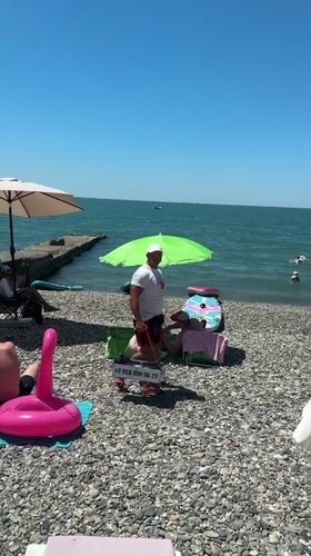 Crowded summer day on Sochi's Black Sea pebble beaches