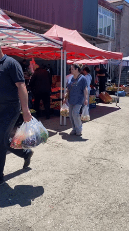 Woman shops at outdoor market in Gyumri, Armenia
