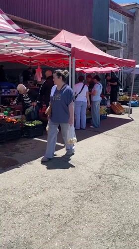 Woman shops at outdoor market in Gyumri, Armenia