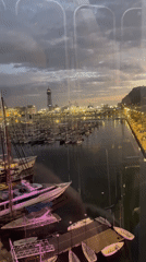 Evening waterfront scenes captured at Barcelona marina and Ferris wheel