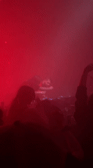 DJ mixing at red-lit nightclub venue