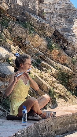 Tourists explore Budva's Old Town walls on a sunny morning