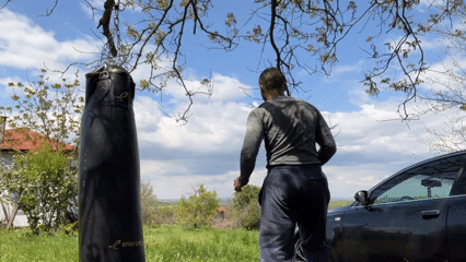 Man conducts outdoor boxing and calisthenics workout session