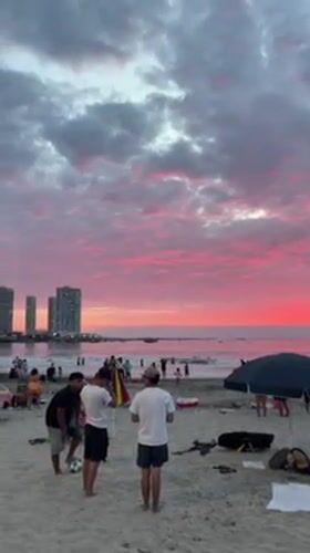 Evening beach gathering with vendors in Iquique, Chile