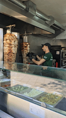 Food vendor prepares shawarma at commercial kitchen establishment
