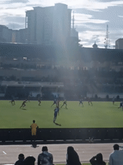 Soccer match underway at Nairobi stadium with spectators