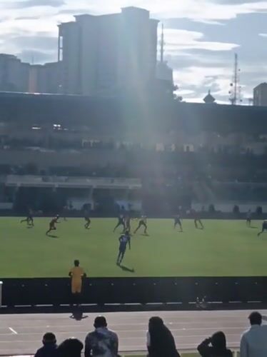 Soccer match underway at Nairobi stadium with spectators