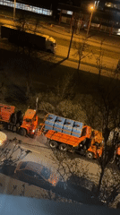 Orange municipal trucks parked in Saint Petersburg industrial area