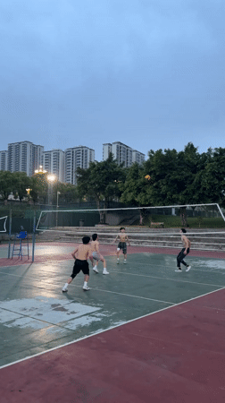 Young men play evening volleyball in Jiangjin, China