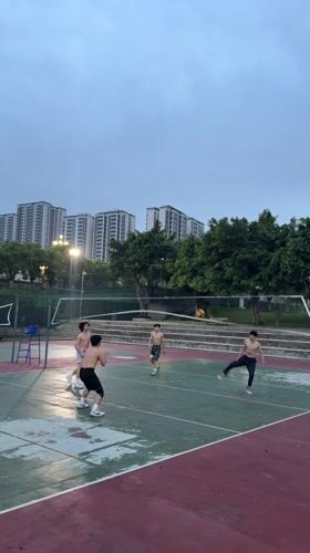 Young men play evening volleyball in Jiangjin, China