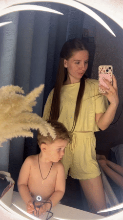 Mother and child capture mirror selfies in Klin bathroom