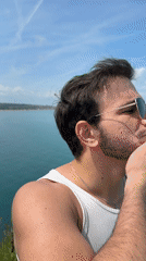 Man poses contemplatively on Sozopol cliff overlooking water
