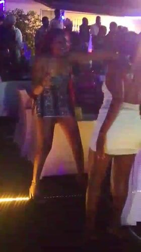 Women dance at outdoor event in Nigerian community