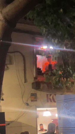 Late-night Barcelona street party with window DJ
