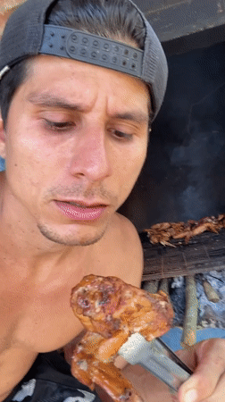 Man grills chicken wings, poses with flowers in Venezuela