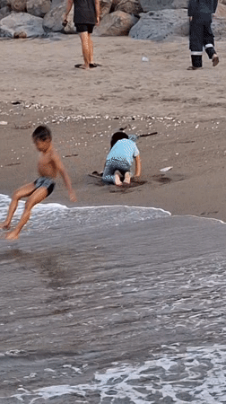 Families enjoy afternoon beach outing in Lhokseumawe, Indonesia