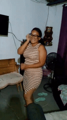 Woman dances, poses at home with dog during May evening