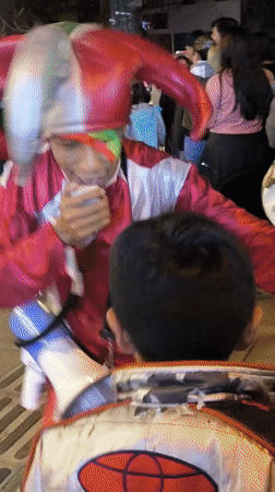 Nighttime crowd gathers outside illuminated building in La Paz