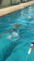 Swimmer practices freestyle in outdoor pool in Nha Trang