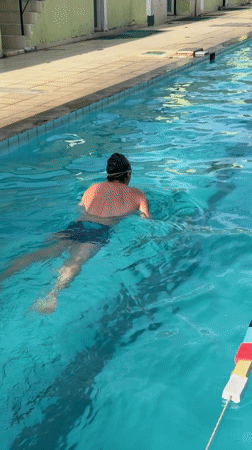 Swimmer practices freestyle in outdoor pool in Nha Trang