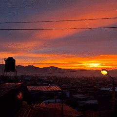 Vibrant sunrise illuminates Mariano Melgar, Peru mountain cityscape