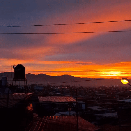 Vibrant sunrise illuminates Mariano Melgar, Peru mountain cityscape