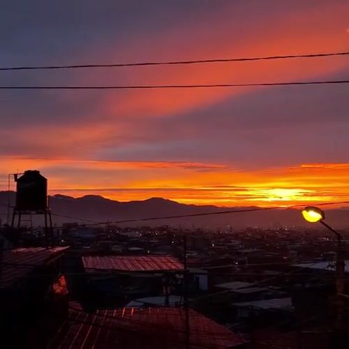 Vibrant sunrise illuminates Mariano Melgar, Peru mountain cityscape