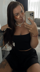 Selfie session with under-eye patches and a shell necklace